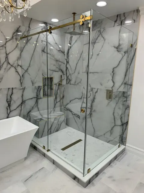 Frameless glass shower in a marble bathroom