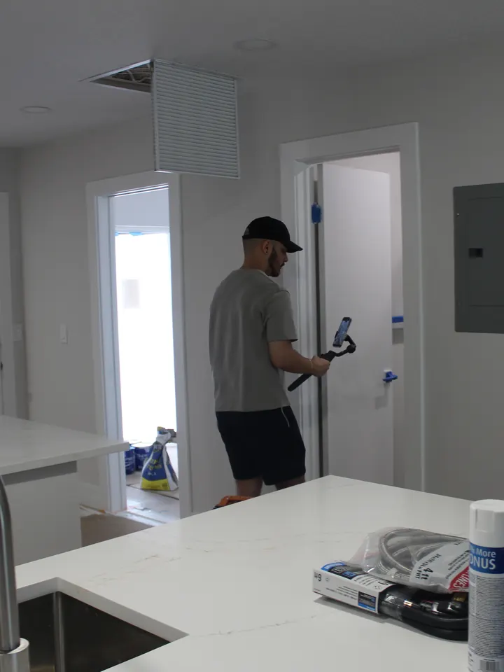 Daniel filming a newly finished kitchen and hallway